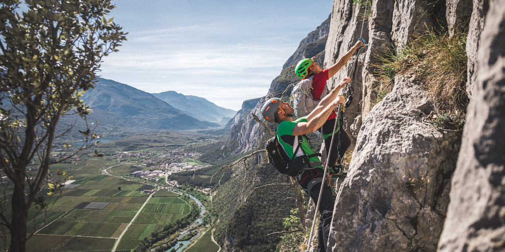 With carabiners and harnesses