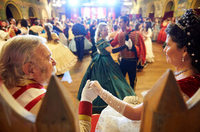 Formal ball scene: a romantic couple dominates a refined, elegant dance.