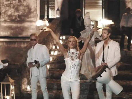  The image shows the group “Miguel Team Group,” consisting of four boys and one girl. They are all dressed in white.