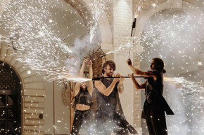 Image of three artists performing a show with fire