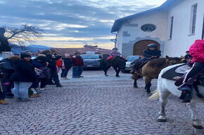 CHILDREN RIDING HORSES IN THE TOWN CENTRE