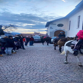 CHILDREN RIDING HORSES IN THE TOWN CENTRE