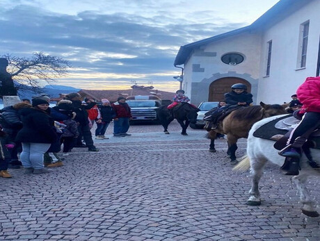 CHILDREN RIDING HORSES IN THE TOWN CENTRE